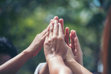 Diversity multiethnic high five group of business people success team hands together. Collaborate Volunteer friendship hands raise up mission Business partner. Group of teamwork high five together
