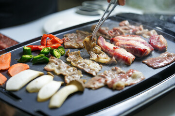 Korean beef barbecue a popular Korean dish with vegetables, green pepper, red pepper, carrot and masroon barbecue. 