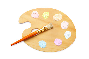 Wooden artist's palette with samples of pastel paints and brush isolated on white, top view