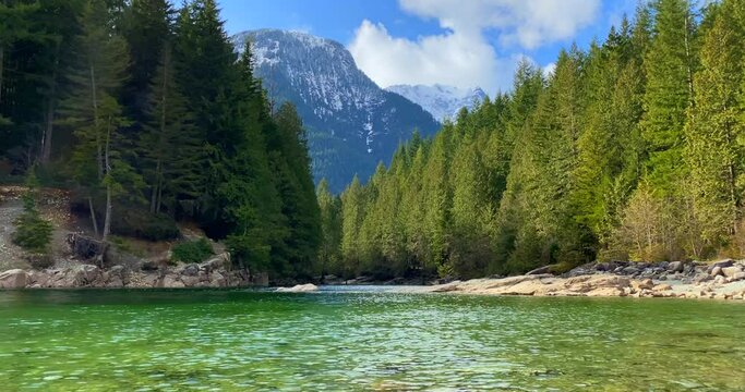 Establishing shot of majestic mountain creek with rocky background in Vancouver, Canada, North America. Day time on September 2021. Still camera view. ProRes 422 HQ.