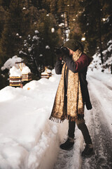 Man Playing in snow-covered winter nature in Dalhousie, Himachal Pradesh, India.
