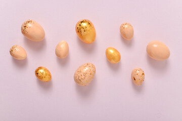 Easter background with painted eggs and sequins. Copy space. Flat lay, top view