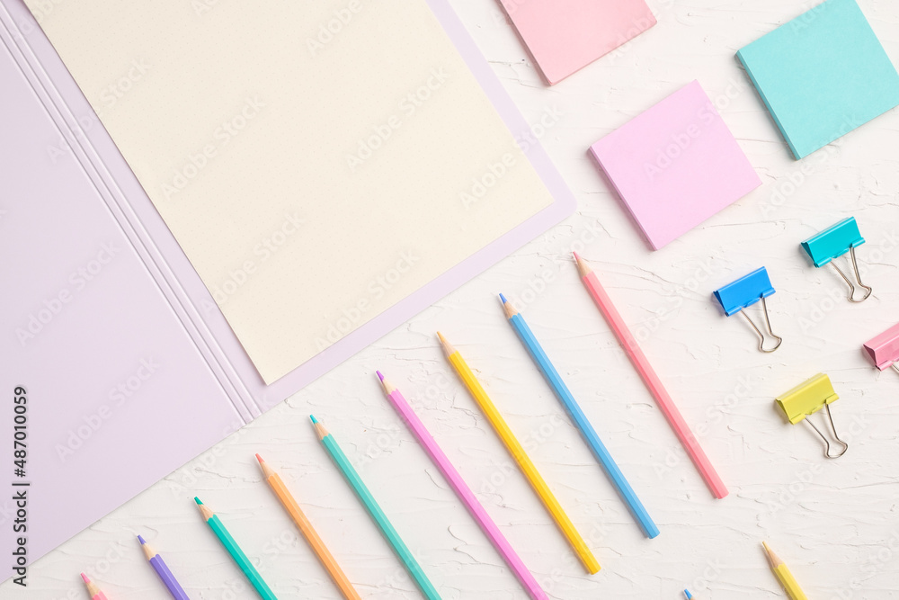 Poster top view of pastel color pencil and file on white table