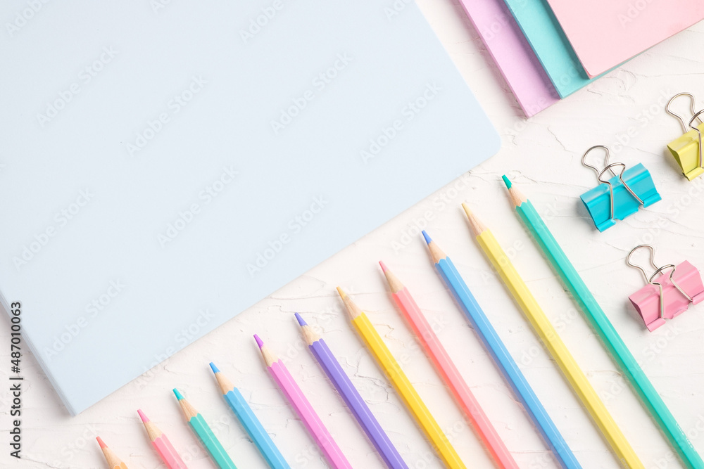Poster top view of pastel color pencil and file on white table
