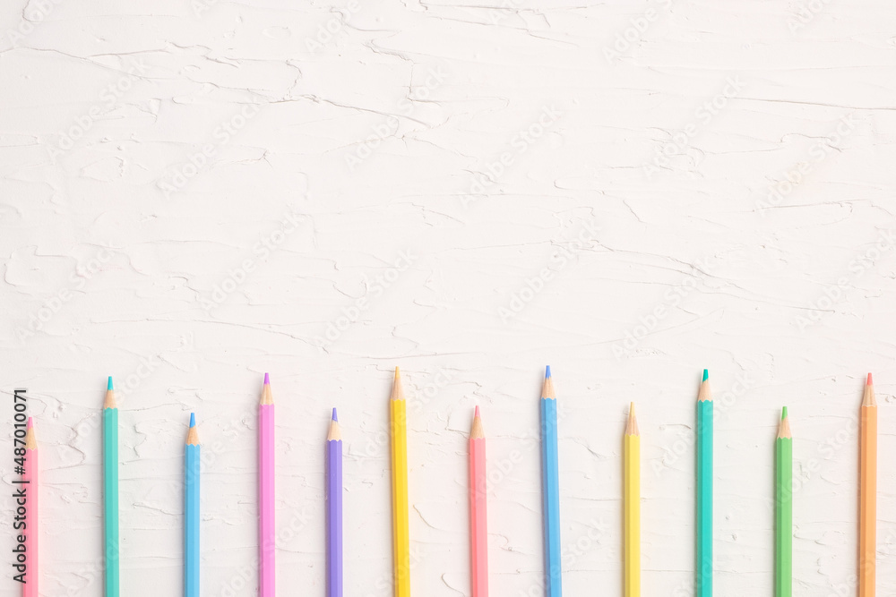 Poster top view of pastel color pencil and file on white table