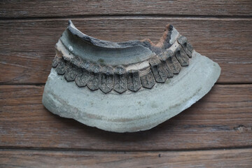 Fragment of jar shoulder decorated with applique of small petals of red bird motif arraying on...