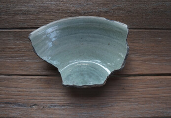 Ancient sample of bowl-piece, coarse stoneware body with light green glazed on interior....