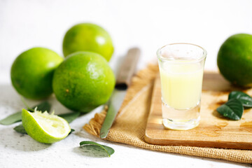 Lime juice and fresh green limes.