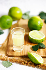 Lime juice and fresh green limes.