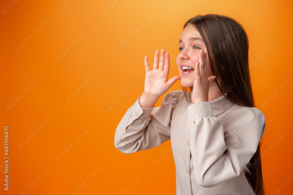 Wall mural teenager girl screaming news on orange studio background