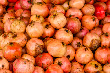 Many pomegranates for sale at the market. Fruit background