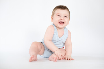child baby boy sitting happy smiling boy on a white 7 month background