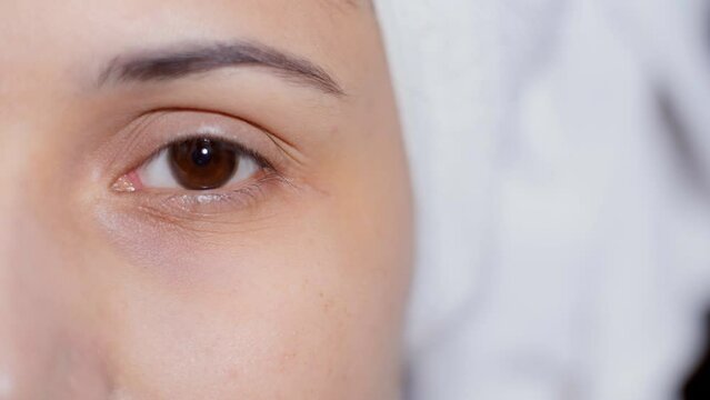 Closeup shot of a female eye - good eyesight  optical vision  skincare  beautiful eyes  eye closeup . Half face of a beautiful woman with her hair wrapped in a towel