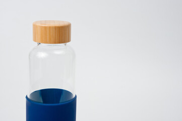 Stylish glass water bottle with wooden lid. For fitness and travel.