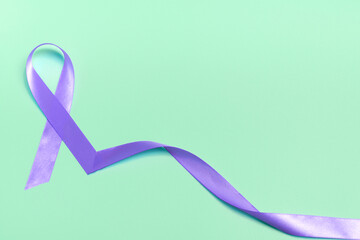 Closeup purple ribbon on a blue background with copy space. World epilepsy day.Banner