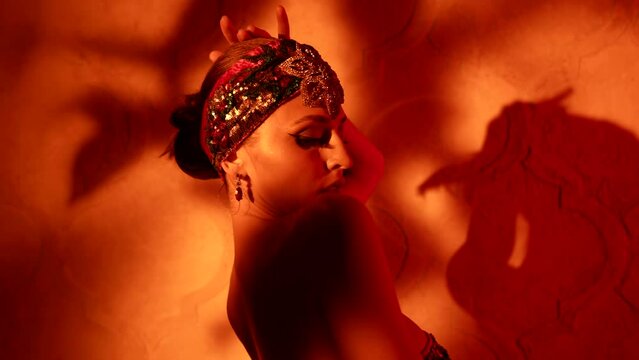 stunning arabian queen is dancing traditional seductive dance, sexy lady in oriental gown for dance