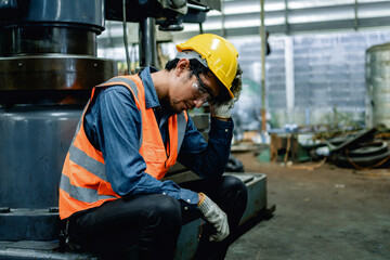 Engineer or Factory worker feeling tired from hard work in a factory, weak, hopeless, burned out,...