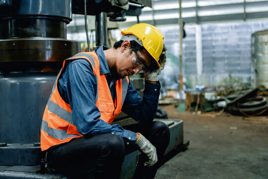 Engineer or Factory worker feeling tired from hard work in a factory, weak, hopeless, burned out, Fired Unemployed Feeling Stressed.
