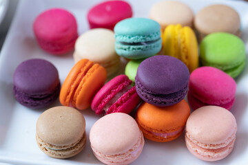 colorful macarons in white plate