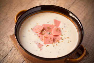 cheese soup with vegetables and ham with toast close-up on the table. horizontal sprinkle oregano...