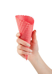 Female's hand holding pink empty crispy ice cream cone isolated