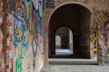 Abandoned building corridor bricked walls with grafiift
