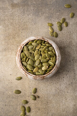 Pumpkin seeds in a bowl, superfoods. Copy space