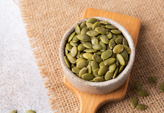 Pumpkin seeds in a bowl, superfoods. Copy space