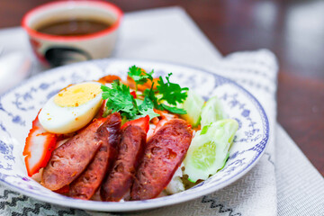 Rice with Red Roast Pork Served Boiled Egg and topped with Sweet Sauce.