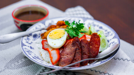 Rice with Red Roast Pork Served Boiled Egg and topped with Sweet Sauce.