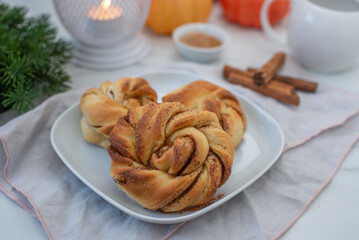 Sweet home made pumpkin cinnamon rolls on a table