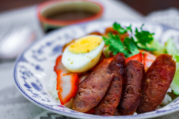 Rice with Red Roast Pork Served Boiled Egg and topped with Sweet Sauce.