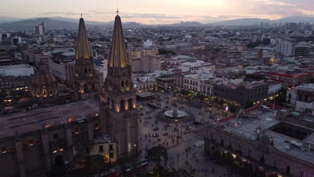 dusk flying counter clockwise around central plaza of Guadalajara Mexico