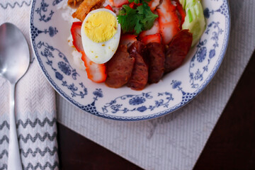 Rice with Red Roast Pork Served Boiled Egg and topped with Sweet Sauce.