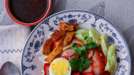 Rice with Red Roast Pork Served Boiled Egg and topped with Sweet Sauce.