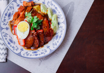 Rice with Red Roast Pork Served Boiled Egg and topped with Sweet Sauce.