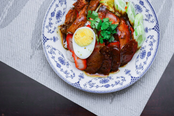 Rice with Red Roast Pork Served Boiled Egg and topped with Sweet Sauce.