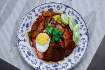 Rice with Red Roast Pork Served Boiled Egg and topped with Sweet Sauce.