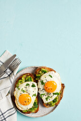 Healthy breakfast with eggs toast and orange juice on blue background