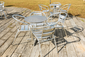 Empty tables with chairs in an outdoor cafe. Close up.