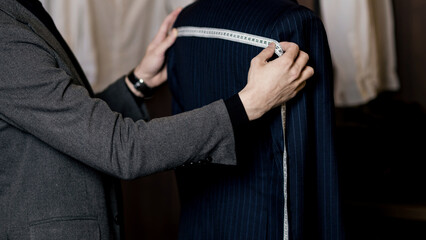 Tailor measuring business man