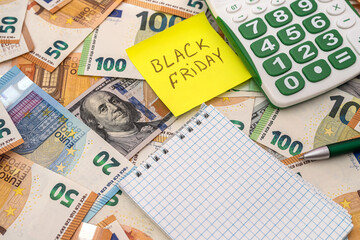 black friday write on memo, dollar and euro money for shopping.