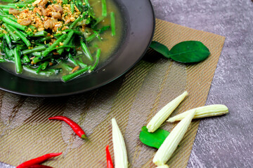 Stir-fried morning glory in a black dish 