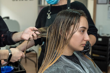 a beautiful young woman with a clean perfect face will be pumped hair dye to dye.
