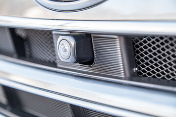 Close up of surround view 360 degrees camera system in the car bumper. Parking assistant and car...