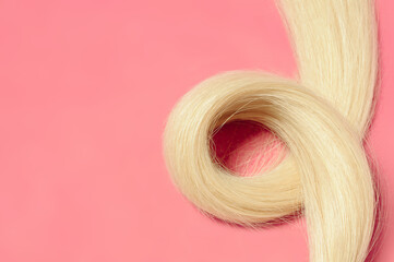 Closeup of Plastic string (Silicone line)tip straight blonde human hair extensions 