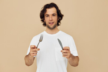 Cheerful man emotions knife and fork kitchenware beige background