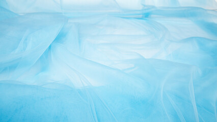 luxury folded light blue tulle fabric texture can be used as a wedding backdrop. Luxury Christmas background or New Year background design.