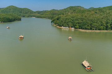 Area of Huai Krathing reservoir for Rafting and Eating at Loei Province, Thailand. Beautiful natural landscape of the river, mountain, blue sky with green forest and bamboo raft shelter.