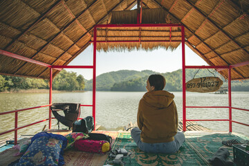 Woman in Area of Huai Krathing reservoir with bamboo raft shelter for Rafting and Eating. Beautiful...
